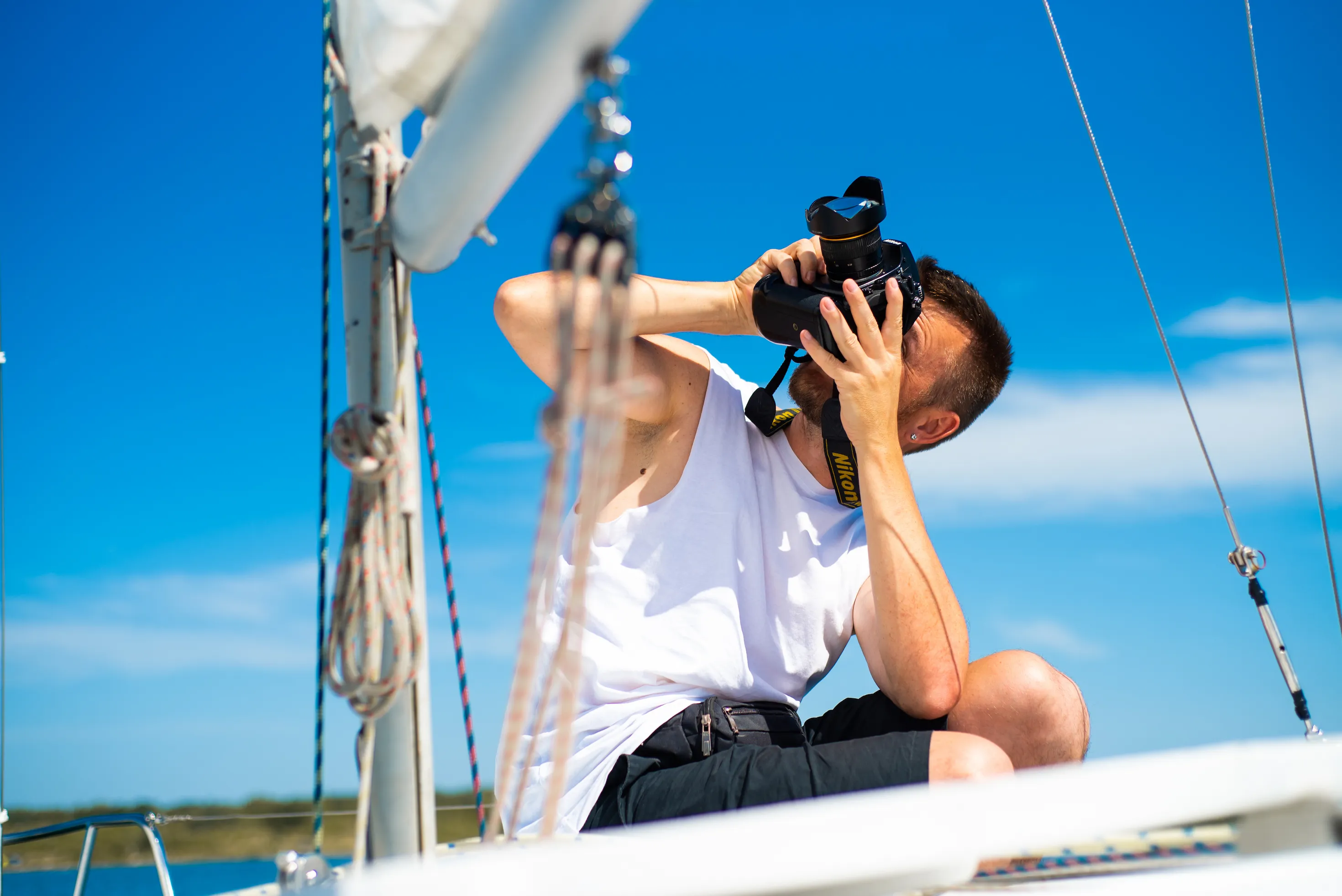 A photographer taking photos of the boat to is going up for sale