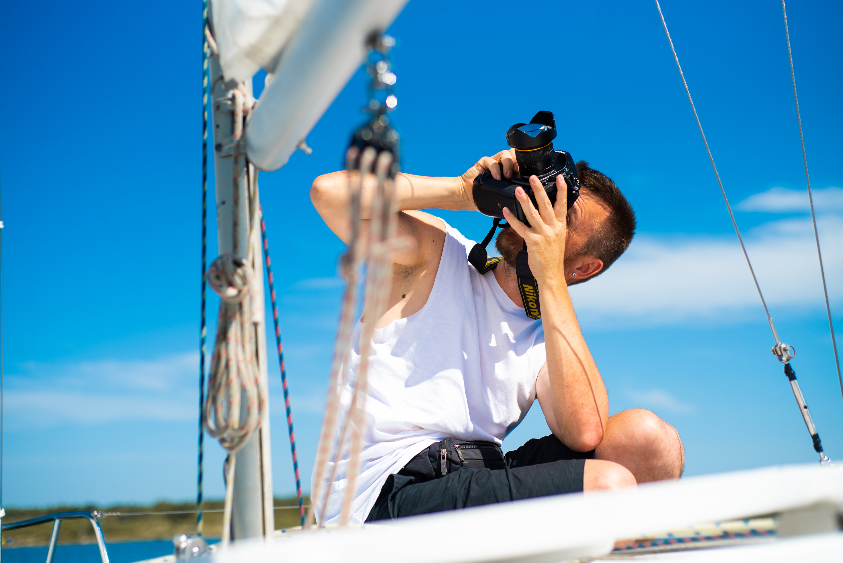 A photographer taking photos of the boat to is going up for sale